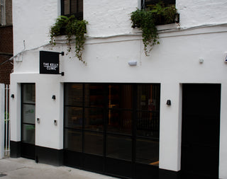 White dublin building with black doors and signs on a street corner